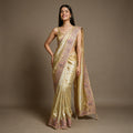 Gold Kanjivaram saree with pink resham, zari and stone work scalloped border and gold blouse, worn