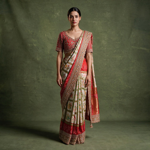Model in a red gajji silk gharchola saree with an ivory checked body, red bandhani borders and a deep handwork border, worn with a red handwork stitched blouse