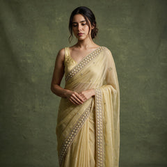 Close-up of the lemon yellow chiffon saree draped over the shoulder, showing the cutdana and bead border and scattered small motifs