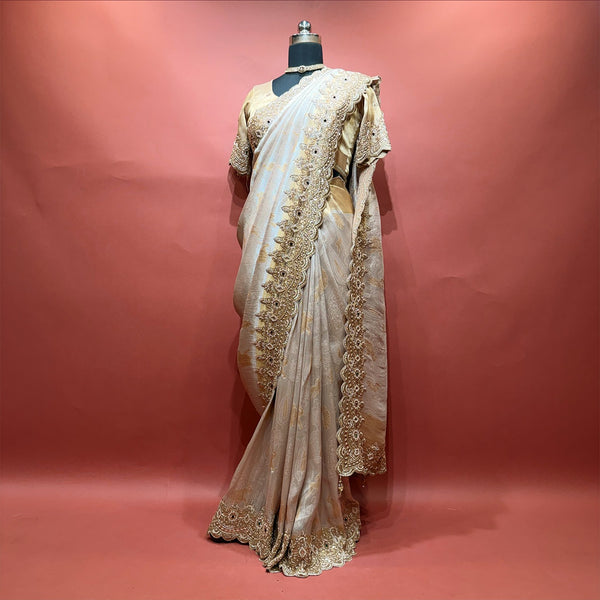 Pearl white viscose silk saree with beaded handwork border and stitched blouse on mannequin
