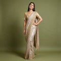 Pearl white viscose silk Kanjivaram saree with beaded and handwork scalloped border and gold blouse, worn