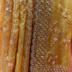 Close-up of pearl, bead and sequin border and pink sequin flower jaal work on yellow organza
