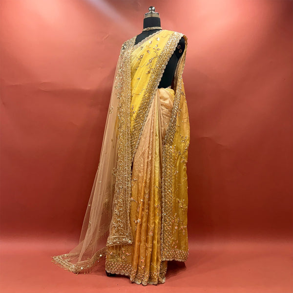 Yellow ombre organza saree with handwork border and jaal work on mannequin
