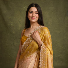 Yellow organza saree with pearl and sequin scalloped border and pink sequin flower jaal work, worn