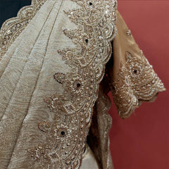Close-up of pearl bead and cutdana flower border and beaded sleeve cuff on champagne tissue