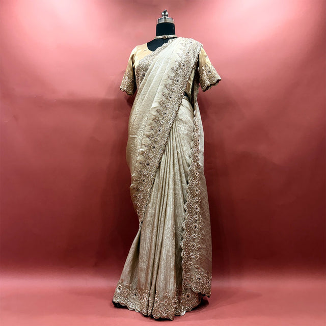 Champagne viscose tissue saree with handwork border and stitched blouse on mannequin