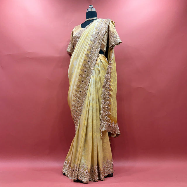 Pale yellow viscose silk saree with beaded handwork border and stitched blouse on mannequin