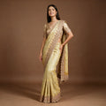 Pale yellow viscose silk saree with scalloped beaded handwork border and champagne blouse, worn