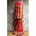 Red khaddi georgette saree with gold zari border and bandhani-style detailing