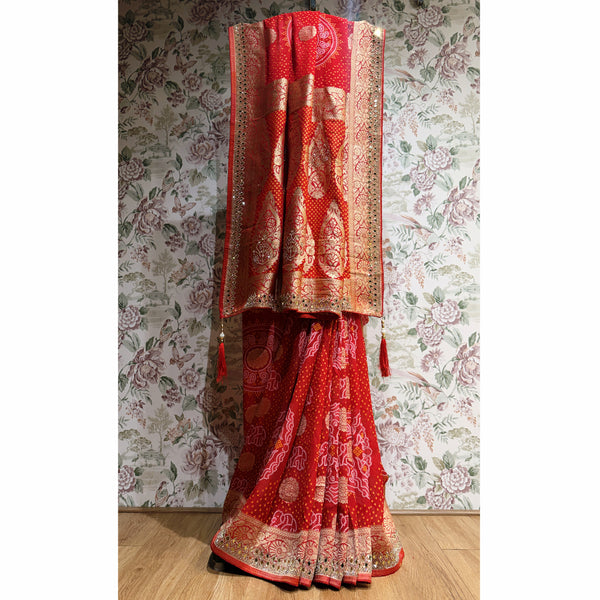 Red khaddi georgette saree with gold zari border and bandhani-style detailing