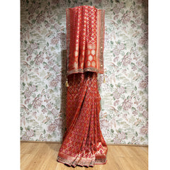 Red georgette saree with bandhani-style pattern and mirrorwork border, draped pallu