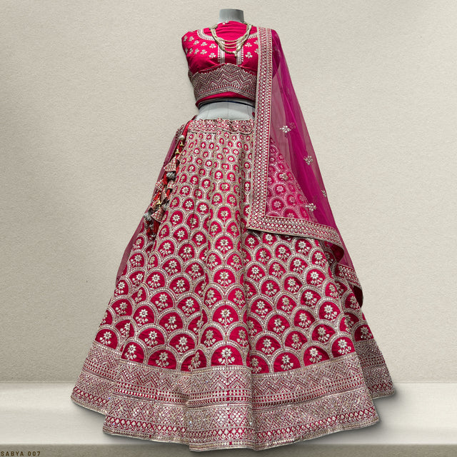 Women's magenta lehenga with embellished bodice, flared skirt, and silver border