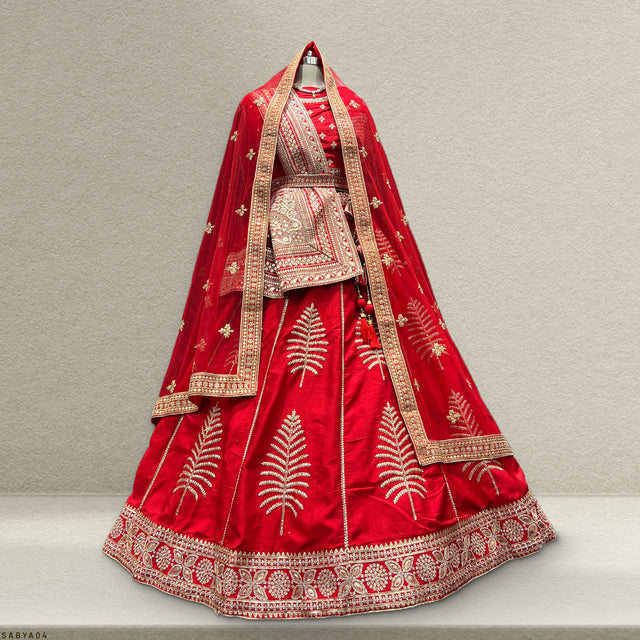 Red raw-silk bridal lehenga with gold trim, ornate embroidery, and matching dupatta