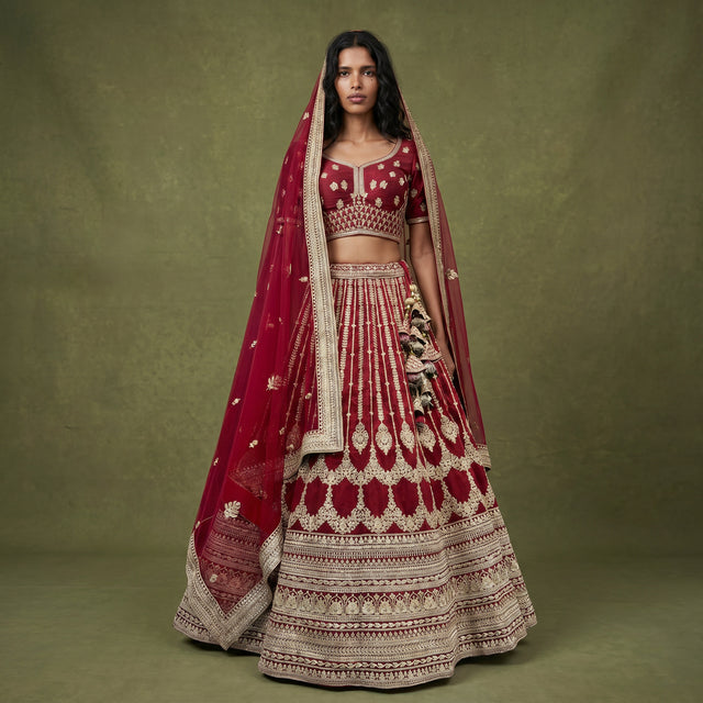 Maroon raw silk bridal lehenga with gold embroidery and matching dupatta