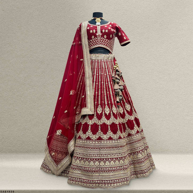 Maroon lehenga back view with gold embroidery and striped hem panels, plus dupatta