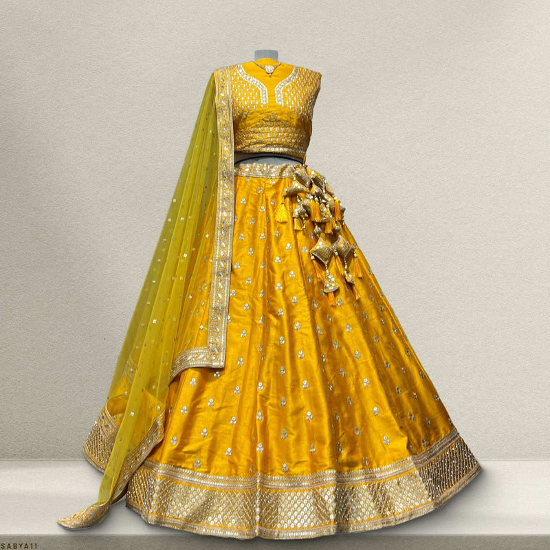 Mustard yellow lehenga skirt with all-over floral sequin motifs and gold trim hem