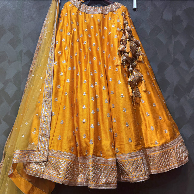 Butter yellow lehenga with allover booti work and zari border hem