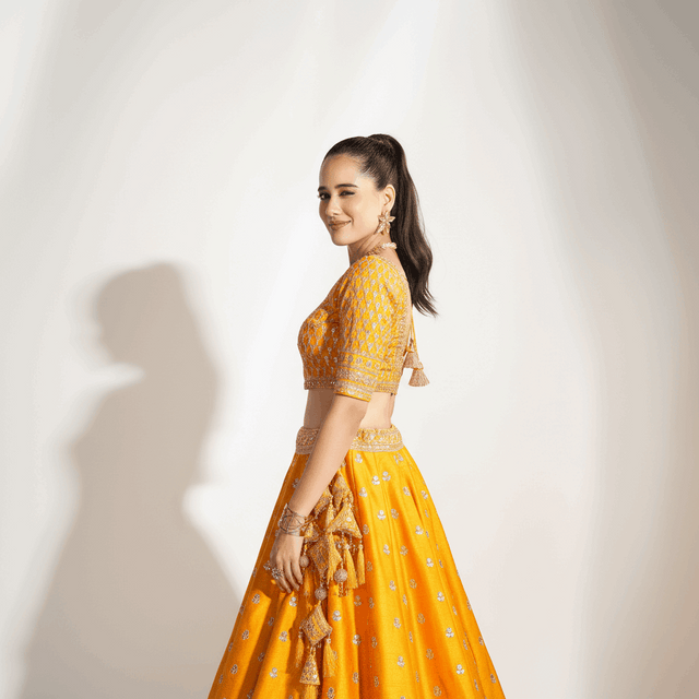 Mustard yellow lehenga with embroidered three-quarter sleeves and draped dupatta