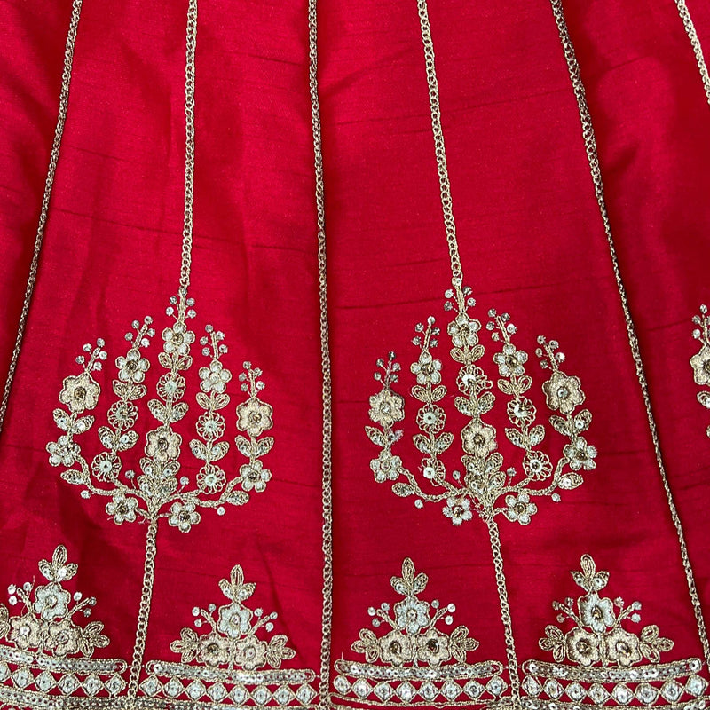 Red lehenga fabric closeup with gold floral vine and chain embroidery