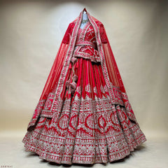 Red tiered bridal lehenga with silver embroidered bands and long veil