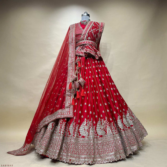 Red lehenga with silver embroidered yoke, tiered skirt, and matching draped dupatta
