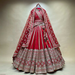 Red and silver embroidered bridal lehenga on hanger, flared skirt with ornate hem border.