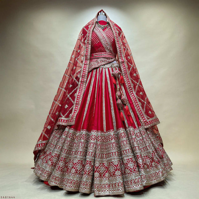 Red bridal lehenga with silver embroidered yoke, flared pleats, and matching dupatta
