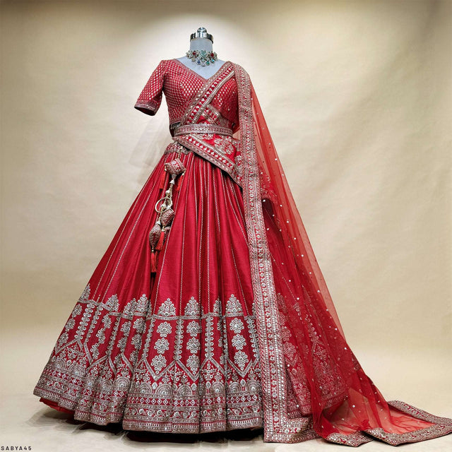 Red bridal lehenga with full skirt, silver geometric embroidery, and matching dupatta