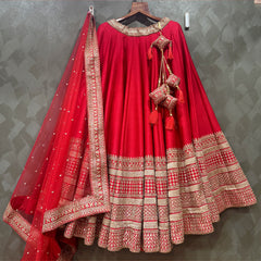 Red bridal lehenga with wide silver-gold border tiers and sheer embroidered dupatta