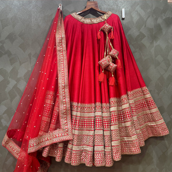 Red bridal lehenga with wide silver-gold border tiers and sheer embroidered dupatta