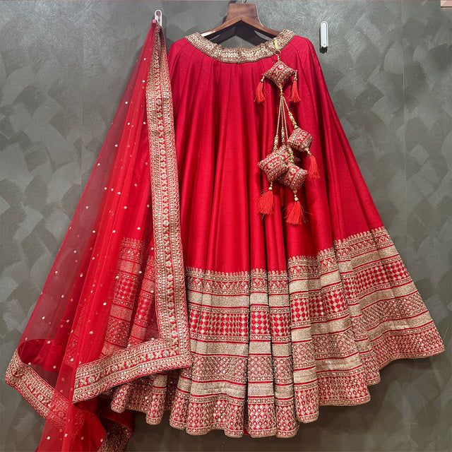 Red bridal lehenga with wide silver-gold border tiers and sheer embroidered dupatta