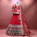 Red bridal lehenga with tiered skirt, gold zari border, and matching dupatta