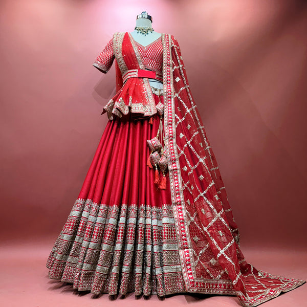 Red bridal lehenga with tiered skirt, gold zari border, and matching dupatta