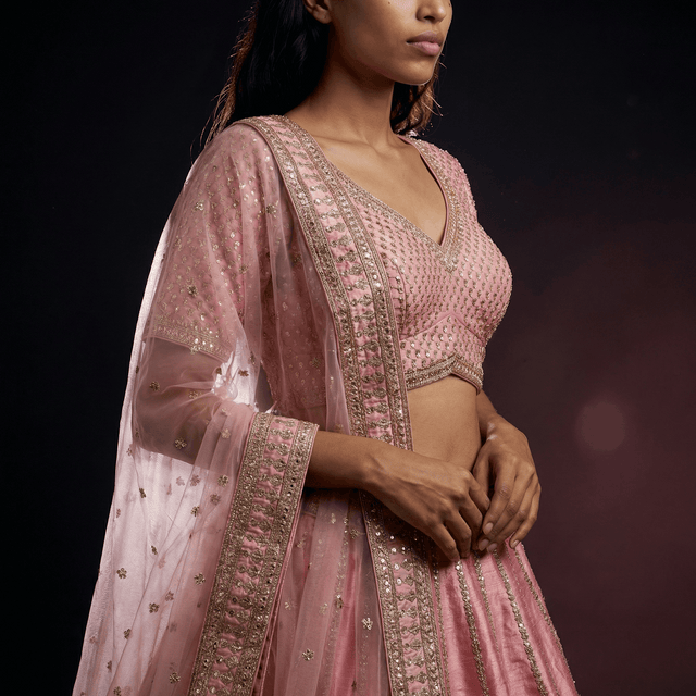 Pink embroidered blouse with V-neck and short sleeves, lehenga set close-up