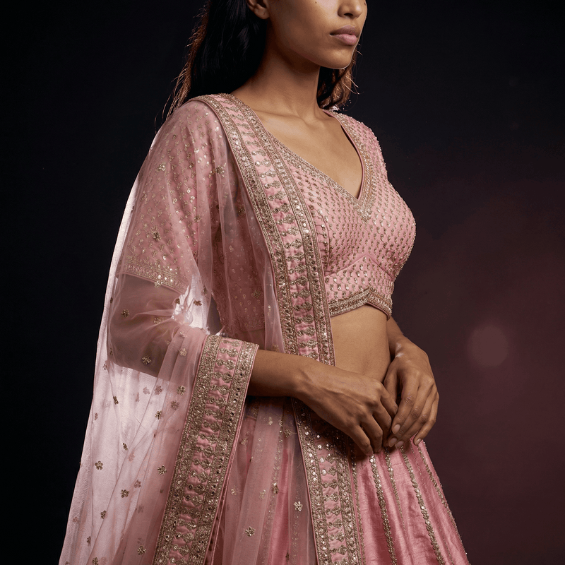 Rose pink lehenga blouse with V-neck, embellished yoke, and sheer embroidered sleeve
