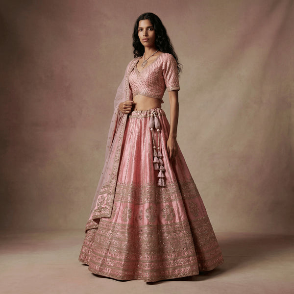 Baby pink raw silk lehenga with short-sleeve blouse and matching dupatta, gold trim