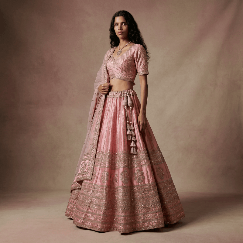 Baby pink raw silk lehenga skirt with silver-toned embroidery and tassel trim