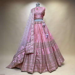 Pink lehenga set on mannequin with embroidered choli, flared skirt, and draped dupatta