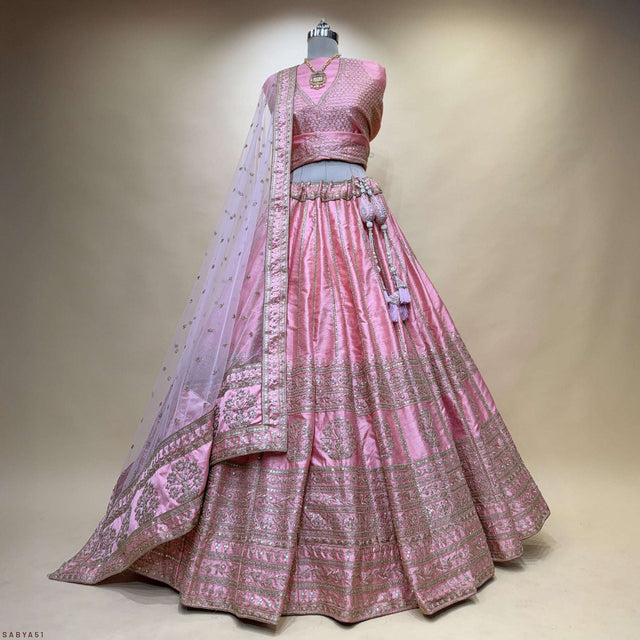 Pink lehenga skirt with tiered embroidery and matching sheer dupatta on mannequin
