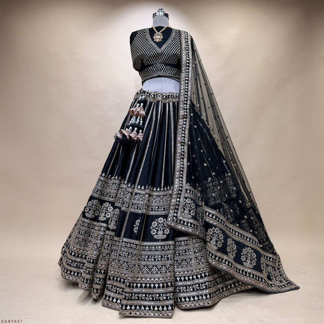 Black pleated lehenga with wide embroidered border and draped net dupatta