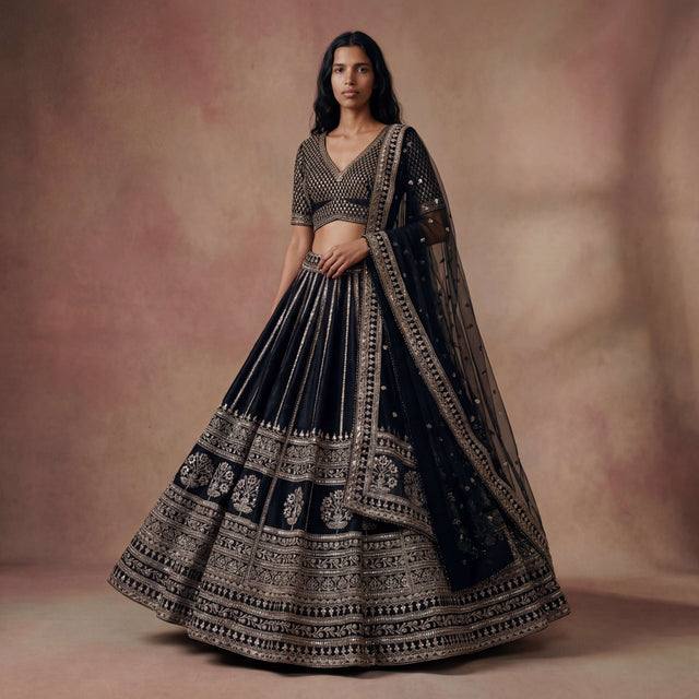 Black lehenga with embroidered blouse and ornate border dupatta
