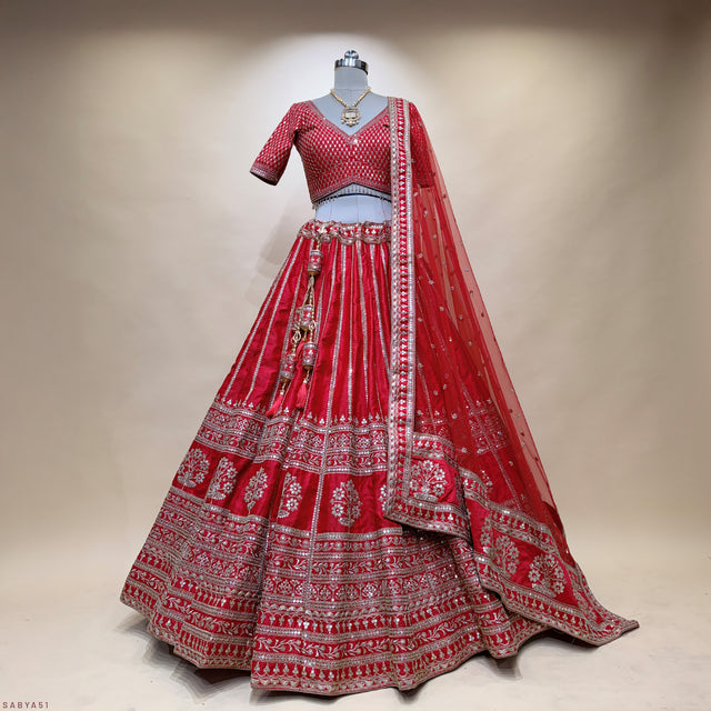 Red bridal lehenga with silver-toned embellishments, circular skirt flares, matching dupatta
