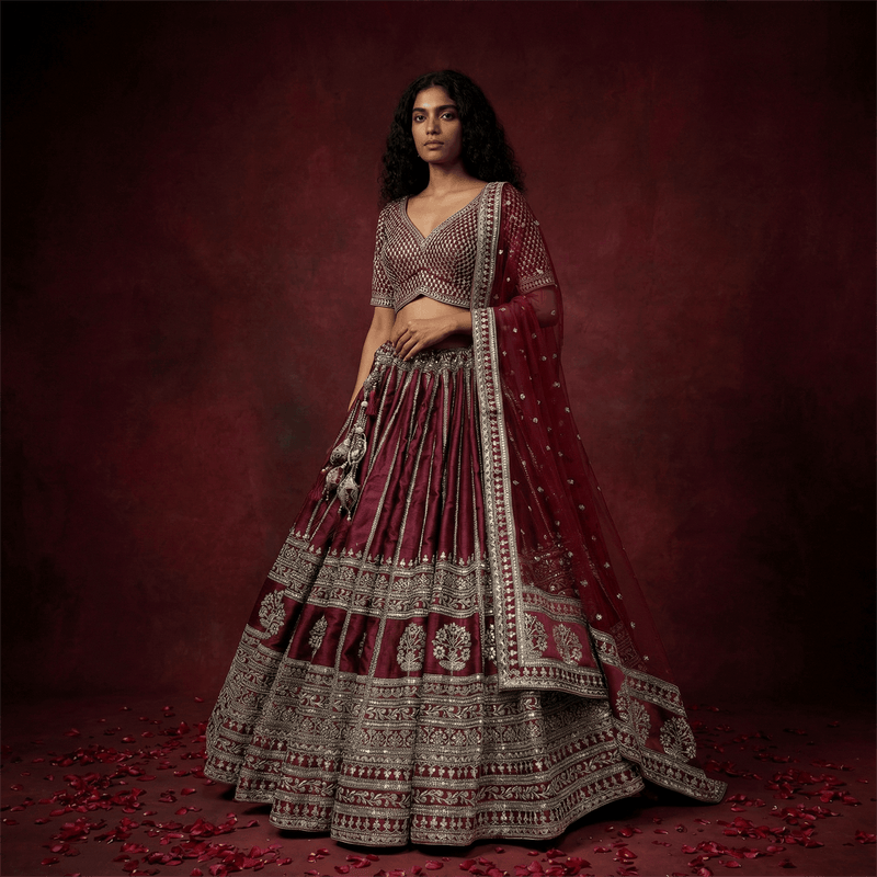 Maroon lehenga with silver embroidered tiers and matching blouse, plus sheer dupatta