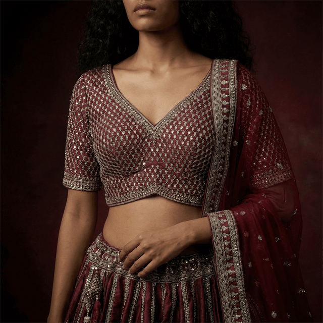 Maroon embroidered bridal blouse with matching tiered lehenga skirt and dupatta