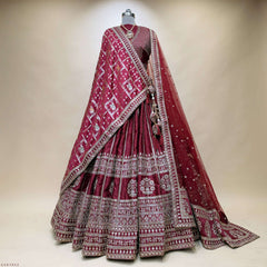 Maroon lehenga skirt with ornate silver border, patterned dupatta drape