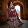 Maroon designer bridal lehenga with embroidered hem and double dupatta
