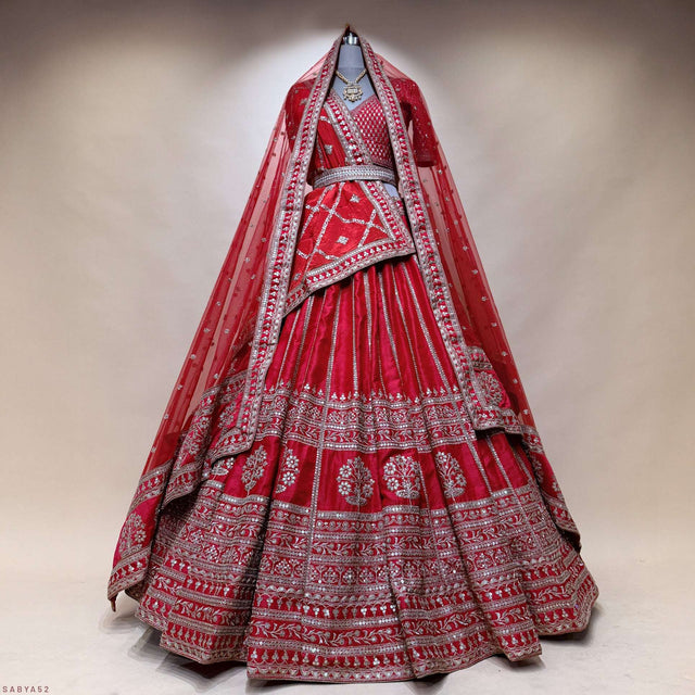 Red bridal lehenga back view with double dupatta and silver embroidered tiers