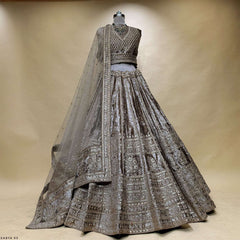 Embroidered velvet lehenga with sheer dupatta on mannequin, tiered sequin trim