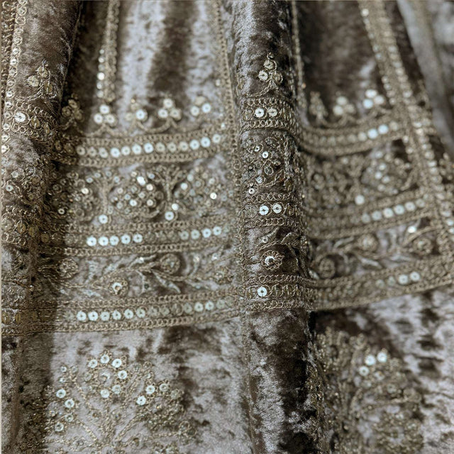 Close-up of velvet lehenga fabric with ornate sequin and bead embroidery bands