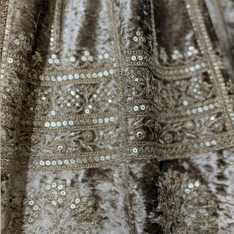 Close-up of velvet lehenga fabric with ornate sequin and bead embroidery bands